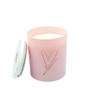 Close-up of the burning Pink Love Geranium & Peppermint Soy Candle with a soft pink glow.